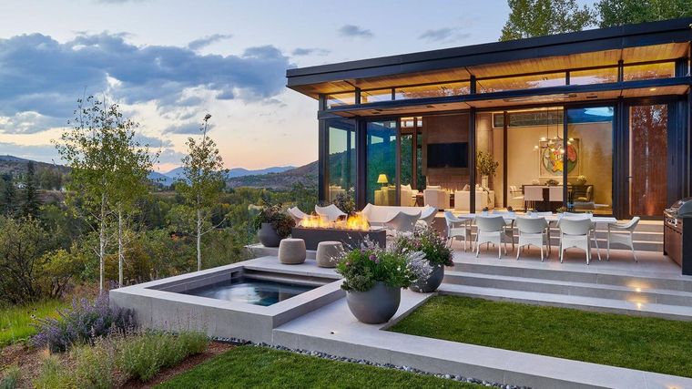 A mountain home terrace at dusk