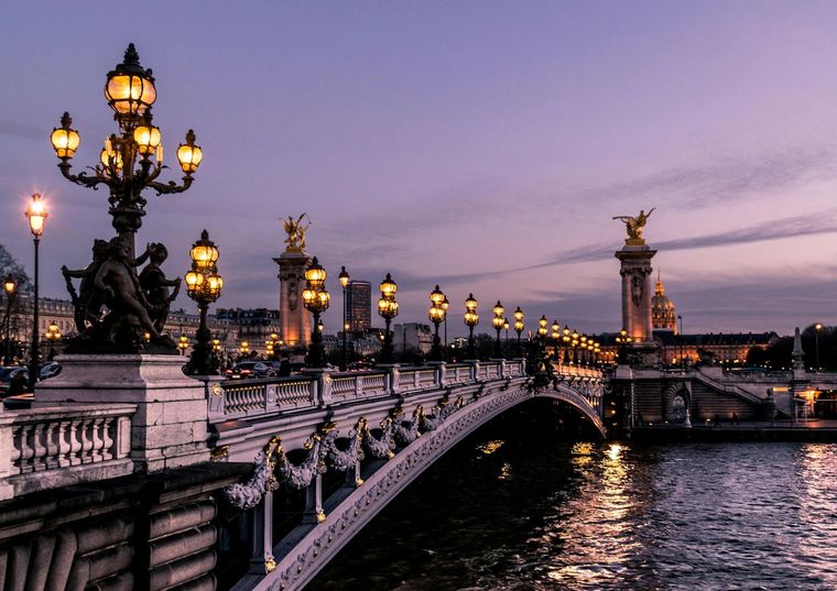 A Paris bridge lit at dusk